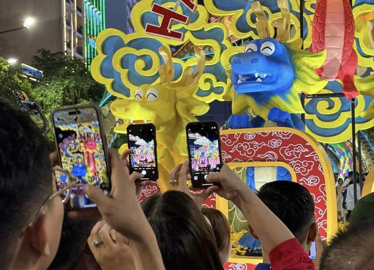 Ai nấy đều mong có được hình ảnh kỷ niệm với những chú rồng con đáng yêu - Ảnh: VŨ NGUYỄN 