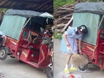 Con gái một tay nâng thùng xe ba gác để quét dọn