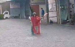 Ông Đắc Lắc chuyên đội mưa chỉ đường cho xe máy, ô tô tránh ngập ở TP.HCM