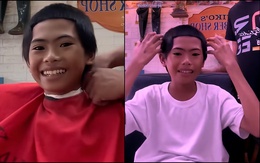 Bé trai gượng cười với kiểu tóc mới