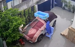 Cả nhà lấy chăn, thảm trùm ô tô để chống bão Wipha